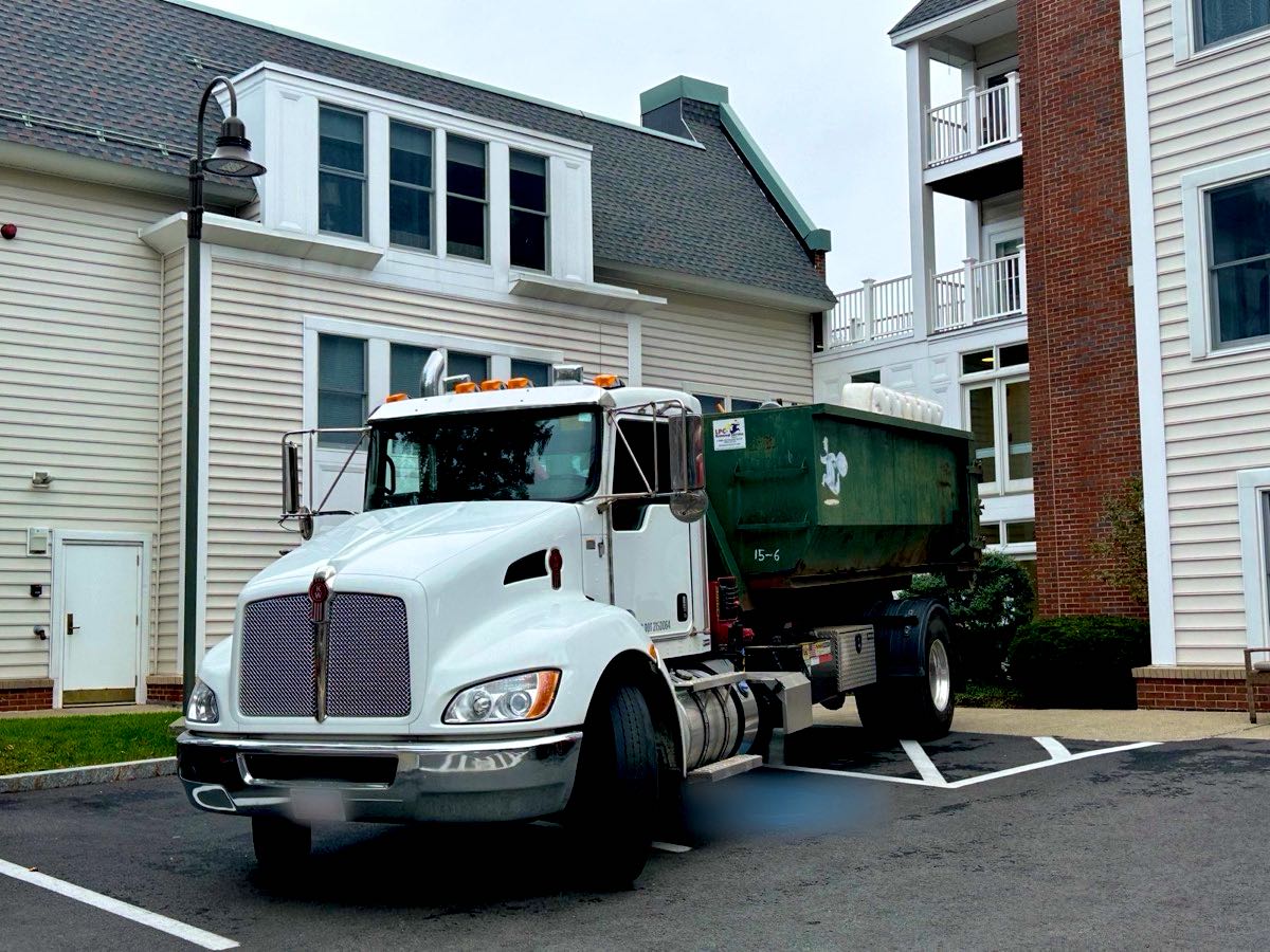 LPC Removal Service junk removal truck at a job in Newton, MA